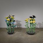 Nathalie Djurberg & Hans Berg The Clearing (White, yellow, blue and black), 2015 Installation with 2 flower platforms and 2 videos Metal, epoxy resin, acrylic paint, wood, hardboard, engine Platform 1: ca. 157 x 105 x 55 cm Platform 2: ca. 153 x 105 x 71 cm Dimensions variable Courtesy: degli artisti, Galleria Gio' Marconi e Lisson Gallery Photo: Jack Hems © Nathalie Djurberg & Hans Berg by SIAE 2017