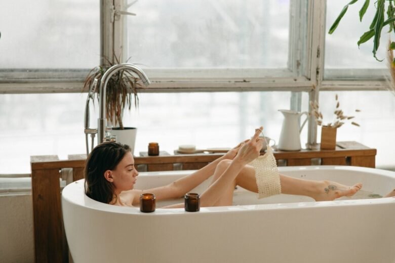 Una ragazza si fa uno scrub nella vasca da bagno