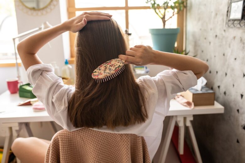 ragazza che si spazzola i capelli